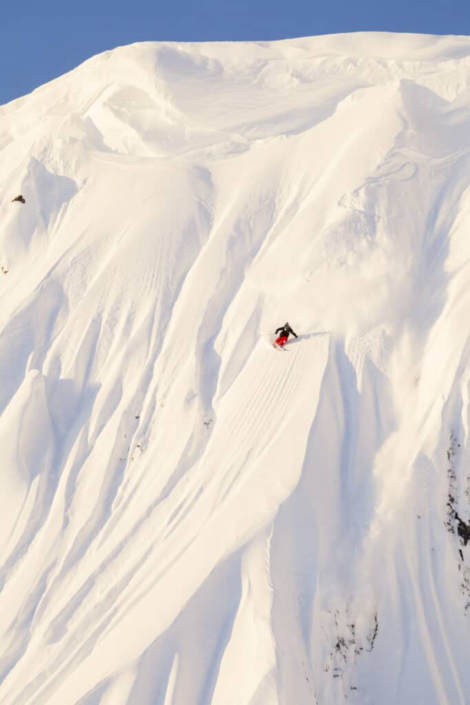 Dane Tudor skis a line at sunrise in Whistler, BC, Canada.